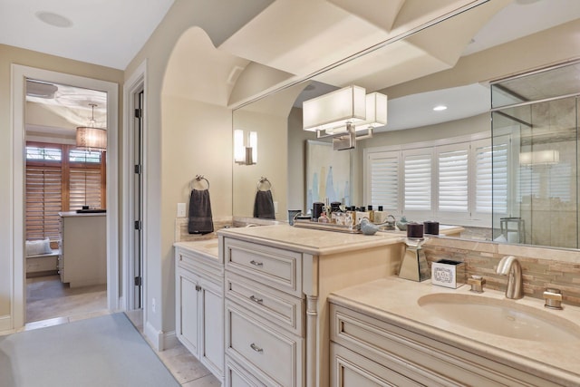 bathroom with tile patterned flooring, vanity, a healthy amount of sunlight, and an enclosed shower