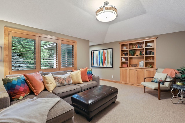 carpeted living room with vaulted ceiling and a textured ceiling