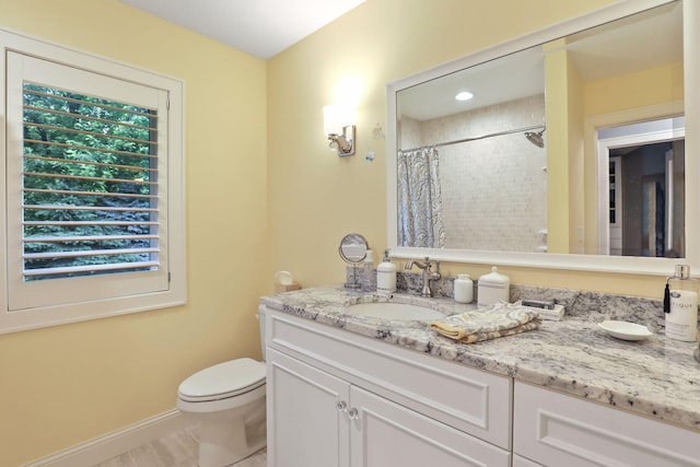 bathroom featuring vanity, toilet, and a shower with shower curtain