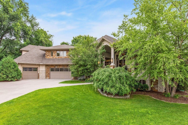 view of front of home with a garage and a front lawn