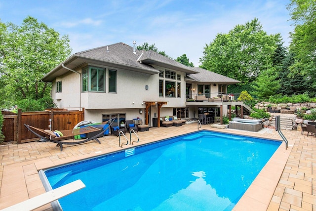 view of pool with a hot tub, a patio, and a diving board