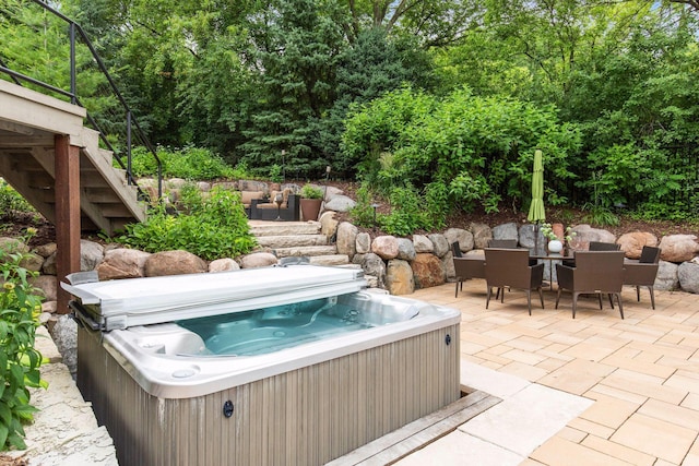 view of patio / terrace with a hot tub and outdoor lounge area