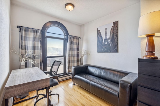 office space featuring a textured ceiling and hardwood / wood-style flooring