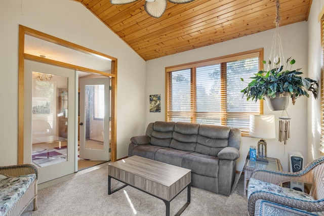 living room featuring ceiling fan, vaulted ceiling, light carpet, and wood ceiling