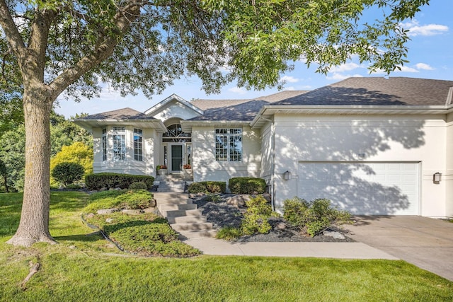 single story home featuring a front yard, concrete driveway, a garage, and a shingled roof