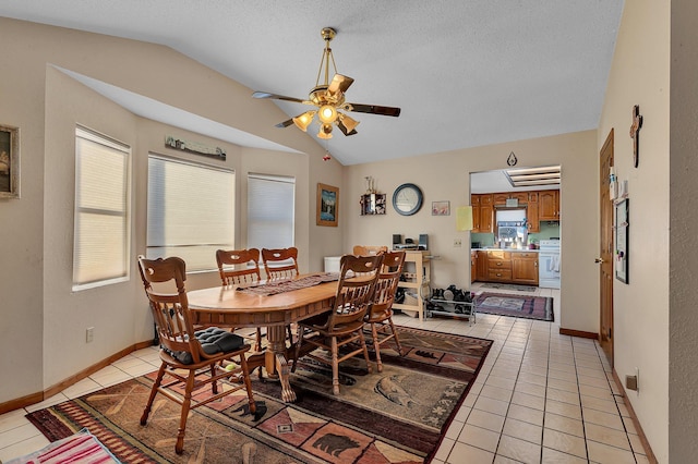 dining space featuring lofted ceiling, light tile patterned flooring, and a healthy amount of sunlight