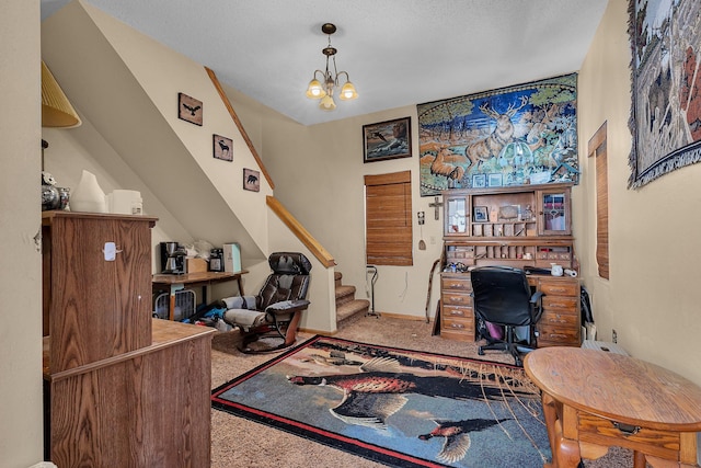 office featuring a textured ceiling, an inviting chandelier, and carpet