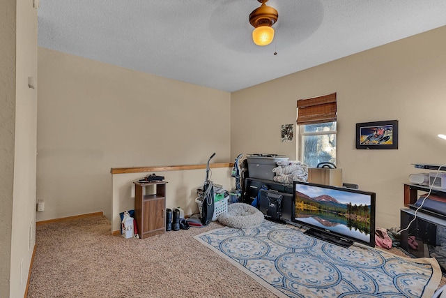 miscellaneous room with a textured ceiling, ceiling fan, and carpet