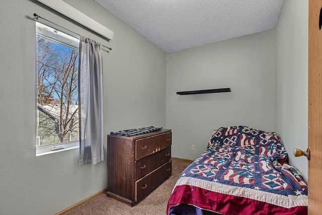 carpeted bedroom featuring a textured ceiling