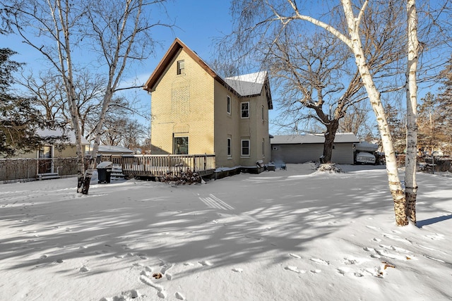 view of snow covered exterior featuring a deck