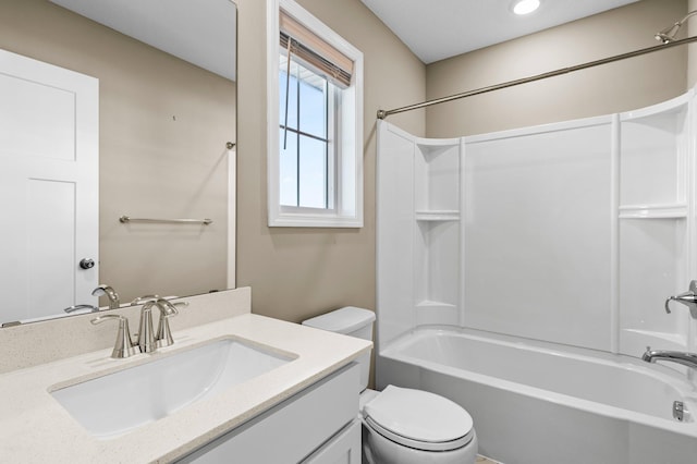 full bathroom featuring vanity, bathtub / shower combination, and toilet