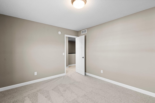 unfurnished room featuring light colored carpet