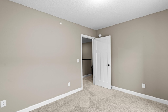 spare room featuring light colored carpet