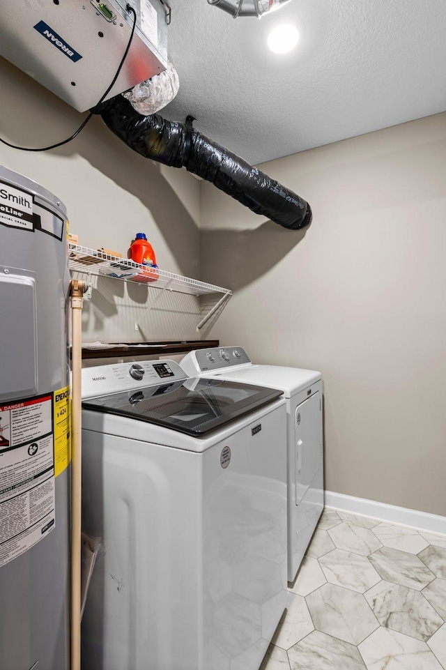 laundry area featuring independent washer and dryer, a textured ceiling, and water heater