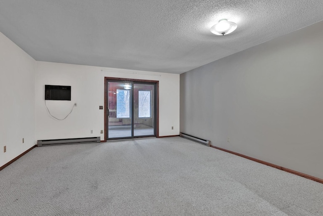 carpeted empty room with a textured ceiling, a wall unit AC, and a baseboard heating unit