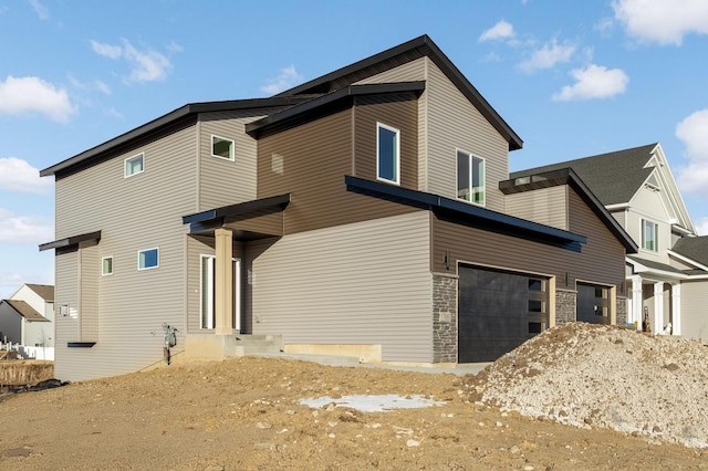 rear view of house featuring a garage