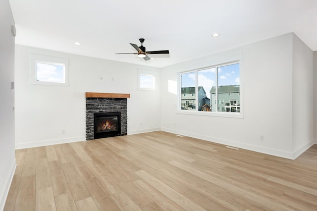 unfurnished living room with a fireplace, light hardwood / wood-style floors, and ceiling fan