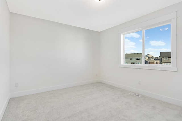 spare room with light colored carpet