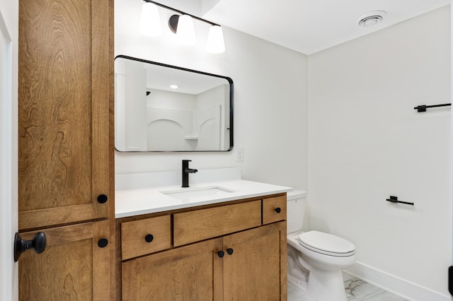 bathroom featuring vanity and toilet