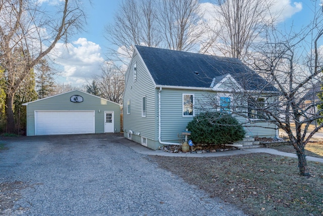 view of side of property featuring an outbuilding and a garage