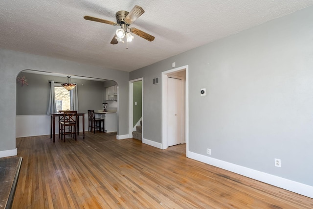 spare room with ceiling fan, a textured ceiling, and hardwood / wood-style flooring