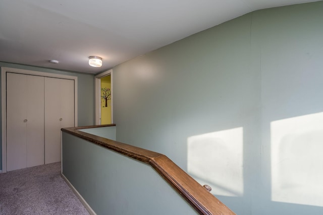 hall with carpet floors and lofted ceiling