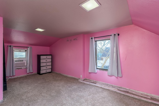 additional living space featuring a textured ceiling, light carpet, cooling unit, and lofted ceiling