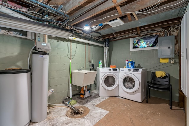 washroom with washing machine and clothes dryer, electric panel, and sink