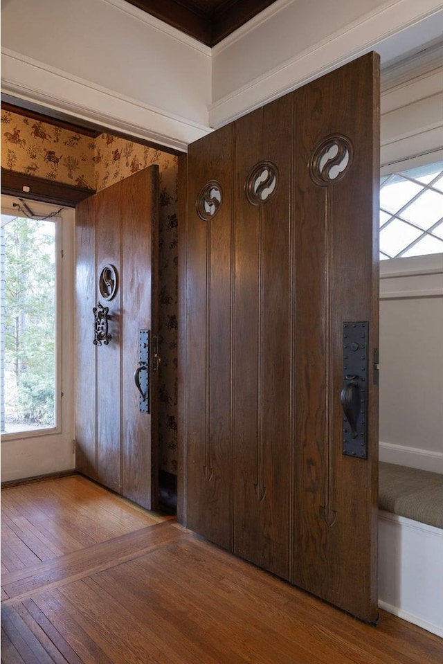 foyer featuring baseboards and hardwood / wood-style flooring