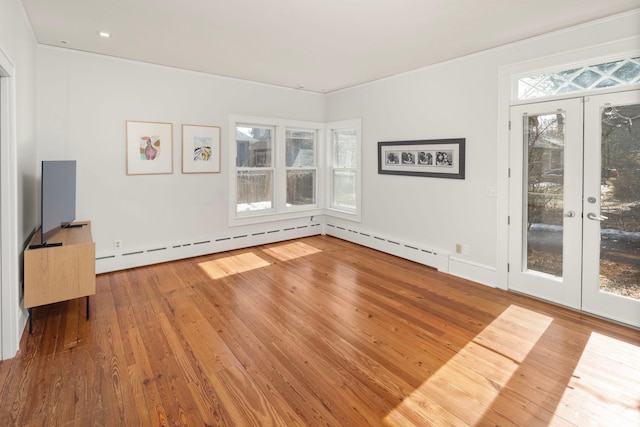 unfurnished living room featuring french doors and hardwood / wood-style flooring