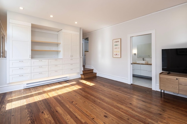 unfurnished bedroom featuring dark wood-style floors, recessed lighting, a sink, ensuite bath, and baseboards