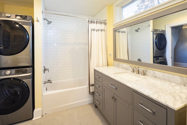 bathroom featuring stacked washer and dryer, shower / tub combo with curtain, vanity, and tile patterned floors