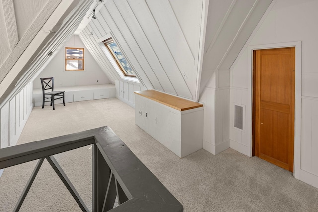 bonus room featuring carpet floors and lofted ceiling with skylight