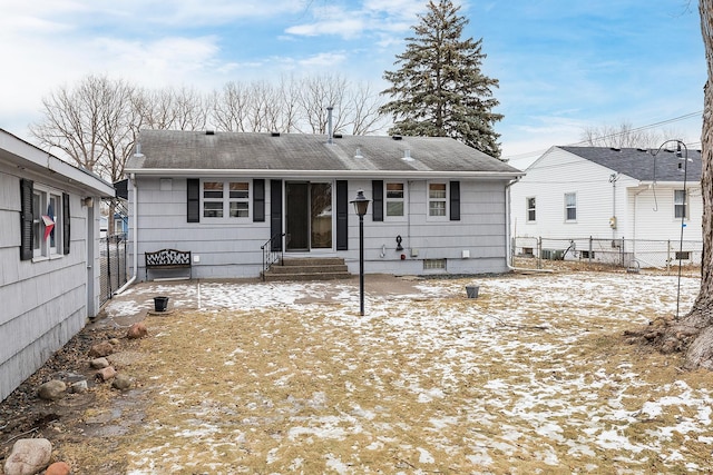 view of snow covered rear of property