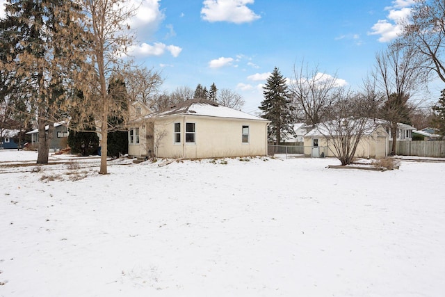 view of snow covered rear of property