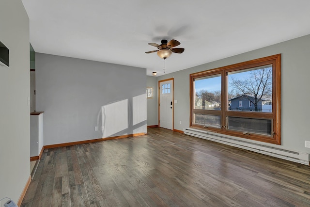 empty room featuring ceiling fan, wood-type flooring, and a baseboard heating unit