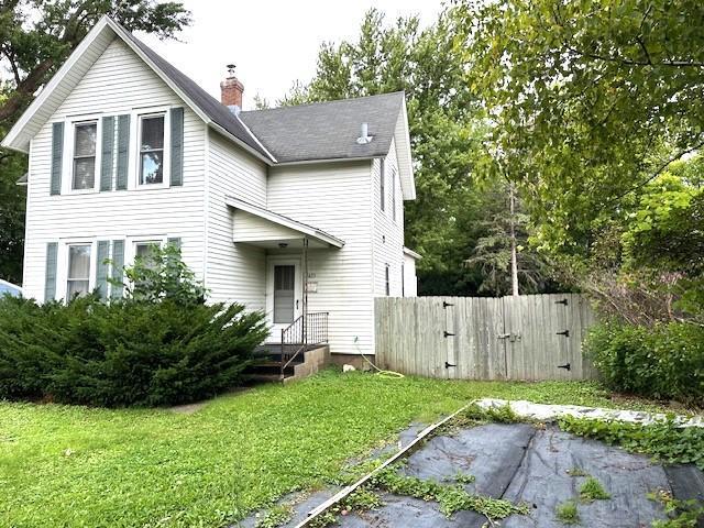 1635 Delano Ave, Maple Plain, MN 55359 - back of house with a gate and a chimney