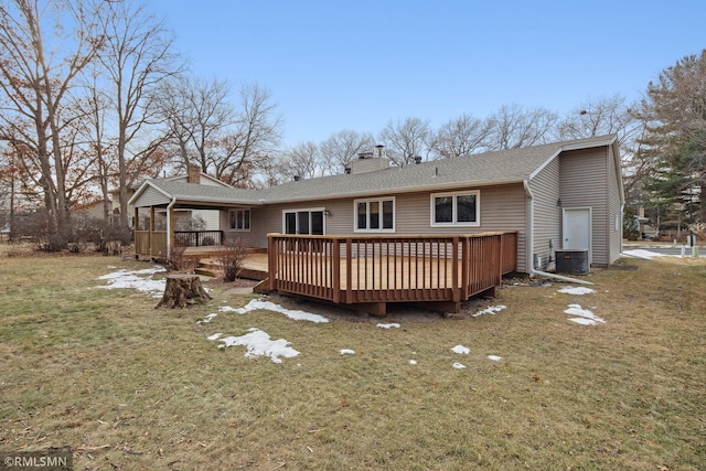 back of property featuring a wooden deck, a yard, and central air condition unit