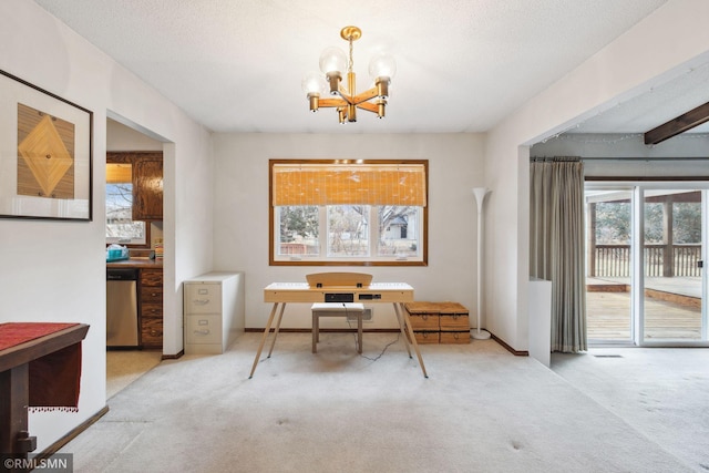 carpeted home office with a chandelier and a textured ceiling