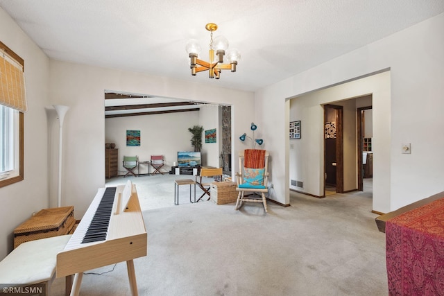 living area with a notable chandelier, beam ceiling, light colored carpet, and a textured ceiling