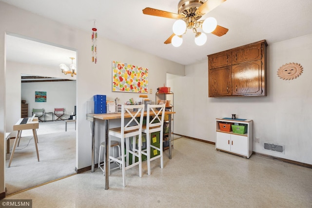 dining area with ceiling fan with notable chandelier