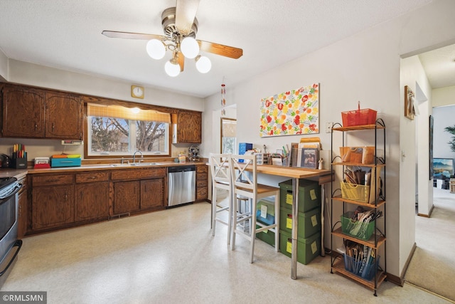 kitchen featuring sink, dark brown cabinets, a textured ceiling, stainless steel dishwasher, and ceiling fan