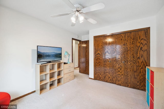 bedroom with light carpet and ceiling fan