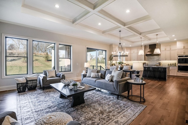 living room featuring crown molding, dark wood-type flooring, coffered ceiling, a notable chandelier, and beamed ceiling