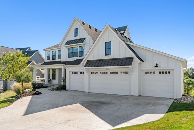 modern inspired farmhouse with a garage