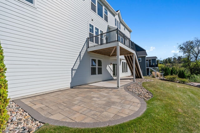 back of house featuring a lawn and a patio