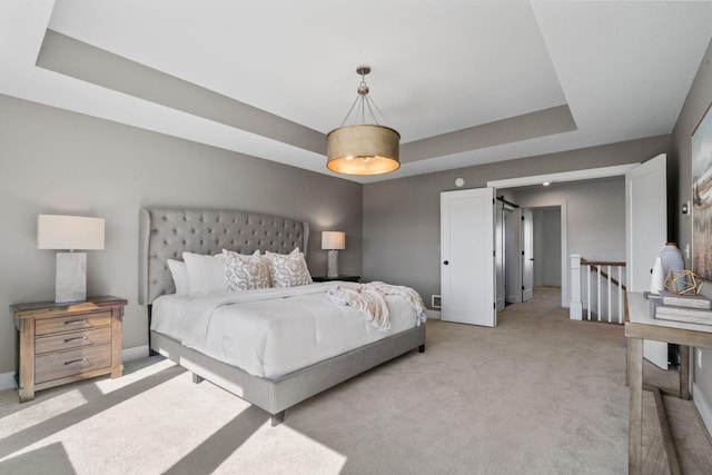 carpeted bedroom featuring a raised ceiling