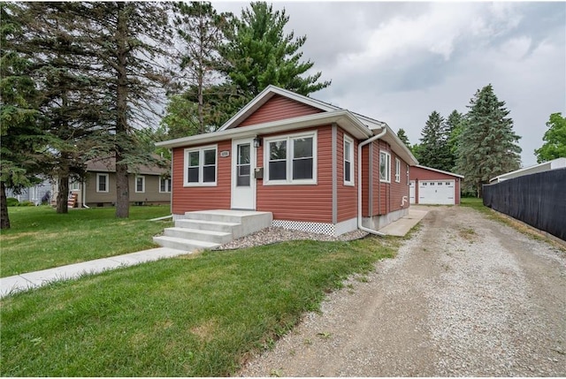 view of front of house with an outbuilding, a garage, and a front yard