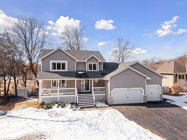 view of front of property with aphalt driveway, a porch, a garage, and roof with shingles