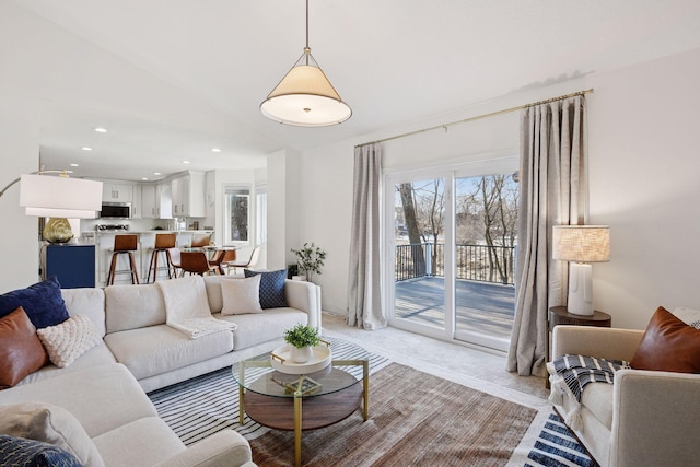 living area featuring light carpet and recessed lighting